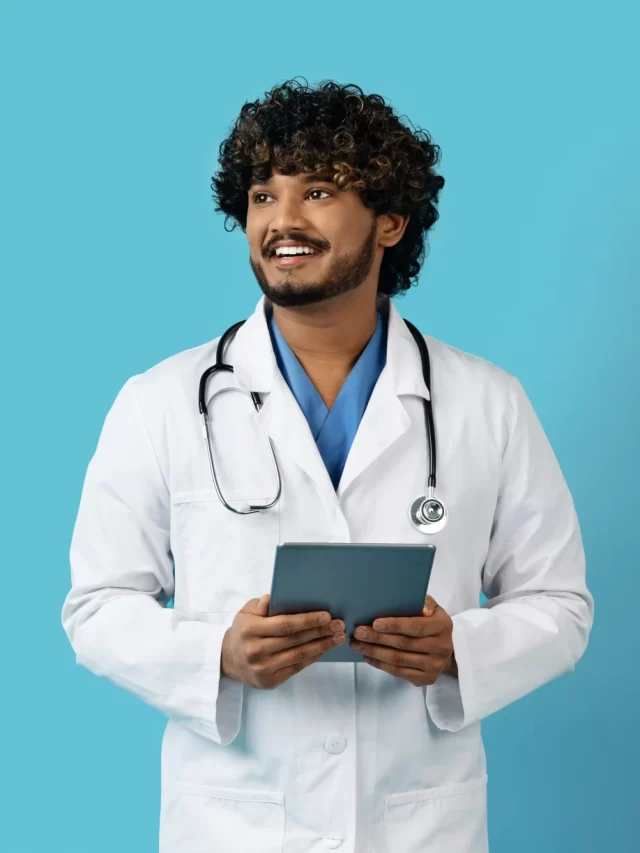 smiling-millennial-eastern-man-doctor-using-digital-tablet-copy-space
