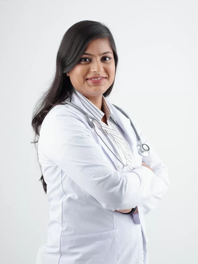 smiling-young-indian-physician-labcoat-crossing-arms-lookig-camera