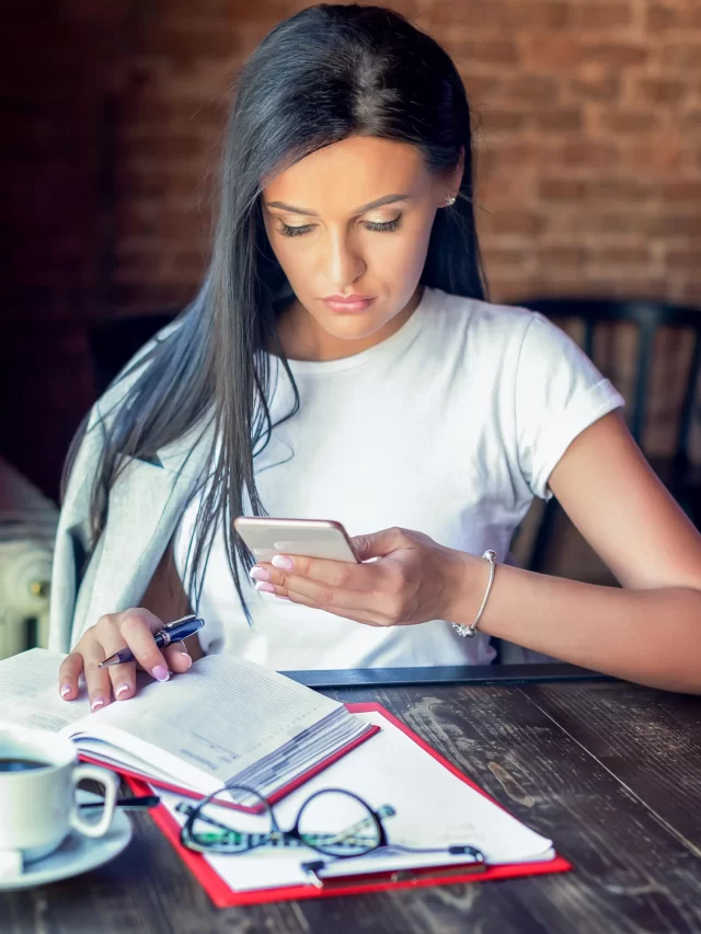 closeup-image-businesswoman-is-holding-using-looking-smart-phone-cafe